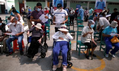 Senior citizens wait to receive a dose of the Pfizer-BioNTech COVID-19 vaccine in Lima, Peru, on March 23 [Sebastian Castaneda/Reuters]